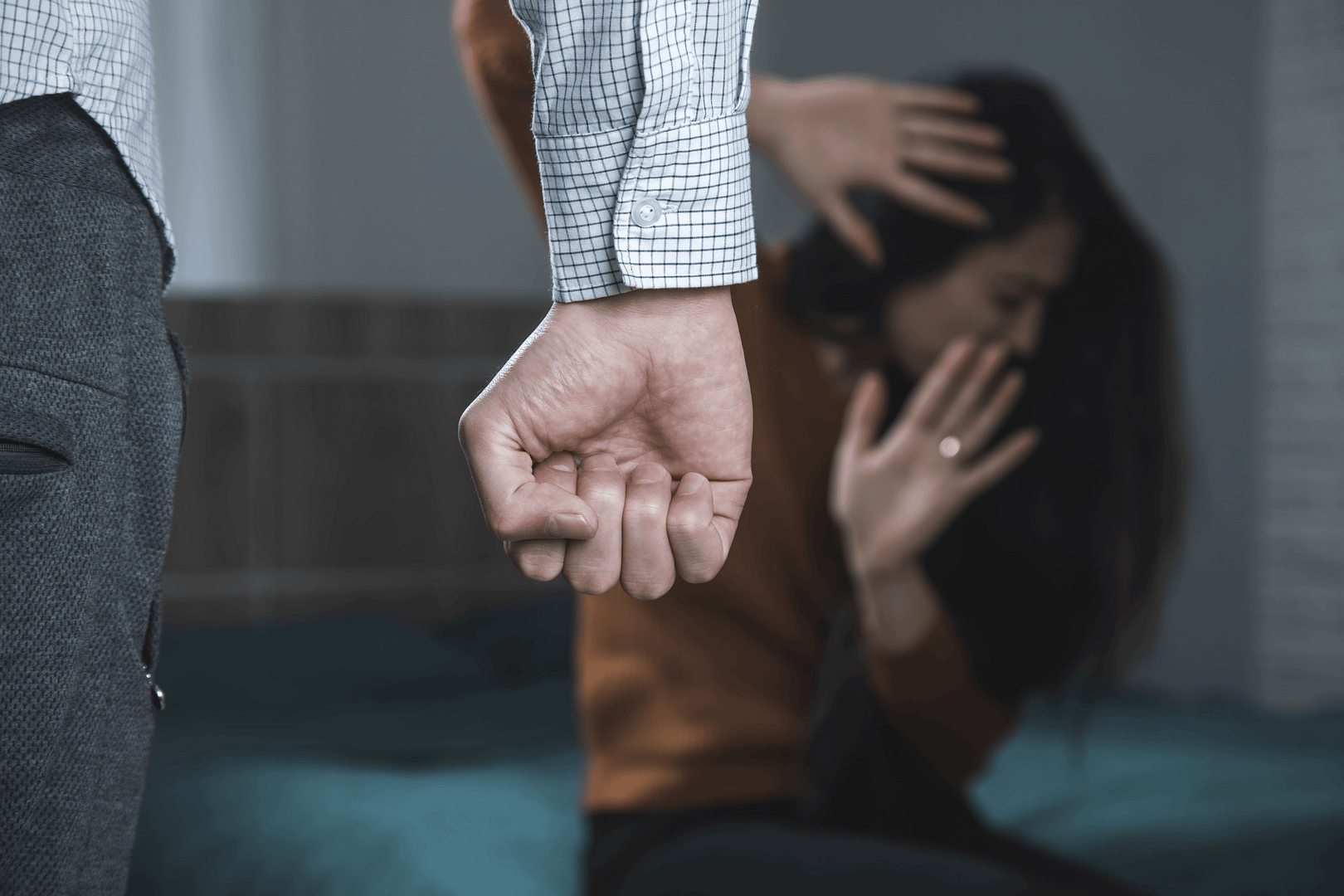 A depiction of women in crisis, showing a distressed woman shielding herself from potential harm, symbolizing the challenges faced in domestic conflicts.